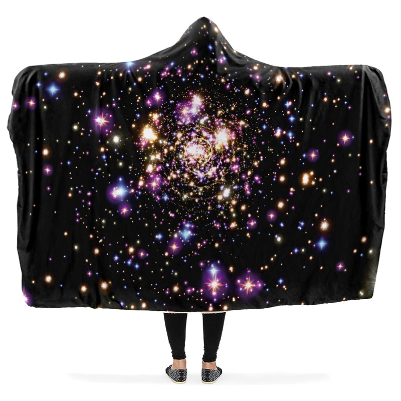 Black hooded blanket with galaxy design worn by a person with arms outstretched.