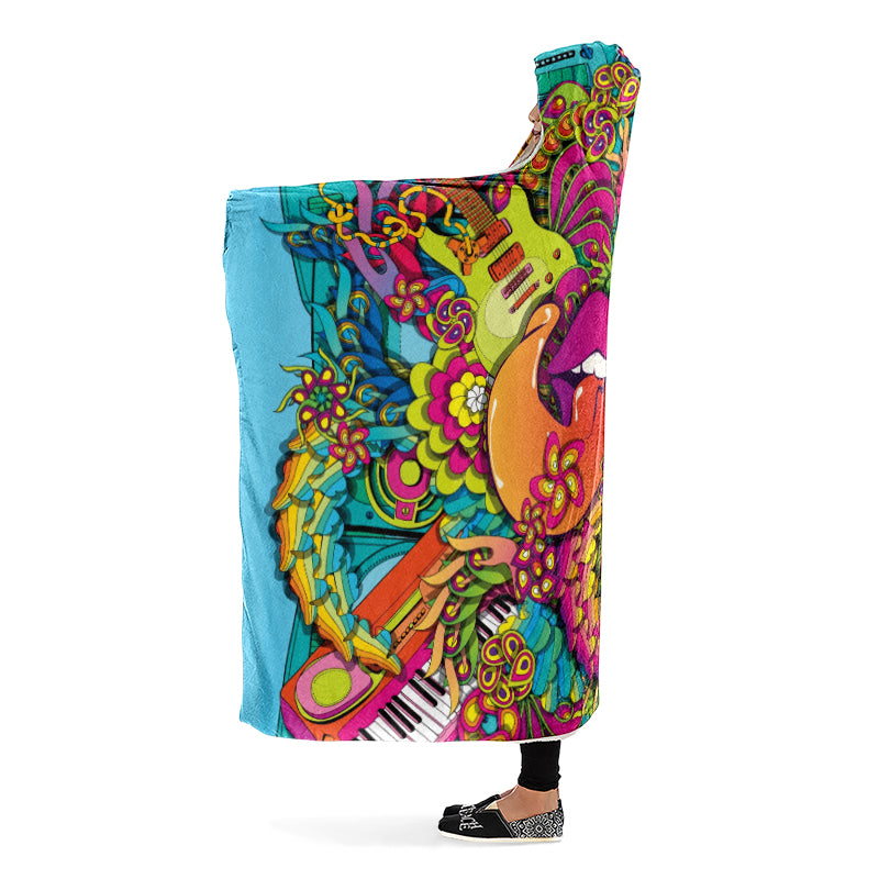 Colorful hooded blanket with a psychedelic design featuring guitars, flowers, and lips with the tongue sticking out. Side view.