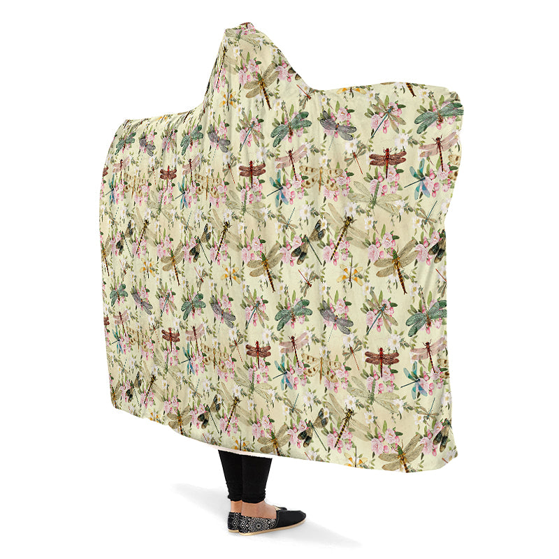 Hooded blanket with dragonfly and floral pattern on a yellow/cream background.