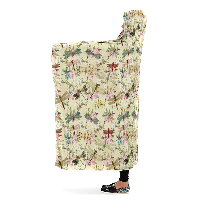 Hooded blanket with dragonfly and floral pattern on a yellow/cream background. Side view.