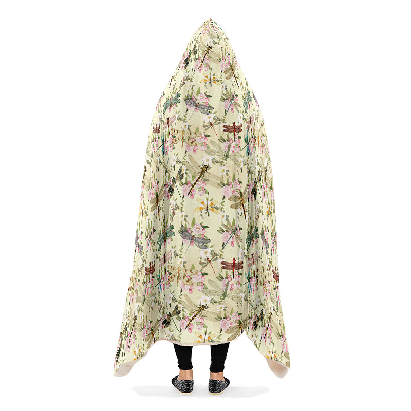 Hooded blanket with dragonfly and floral pattern on a yellow/cream background.