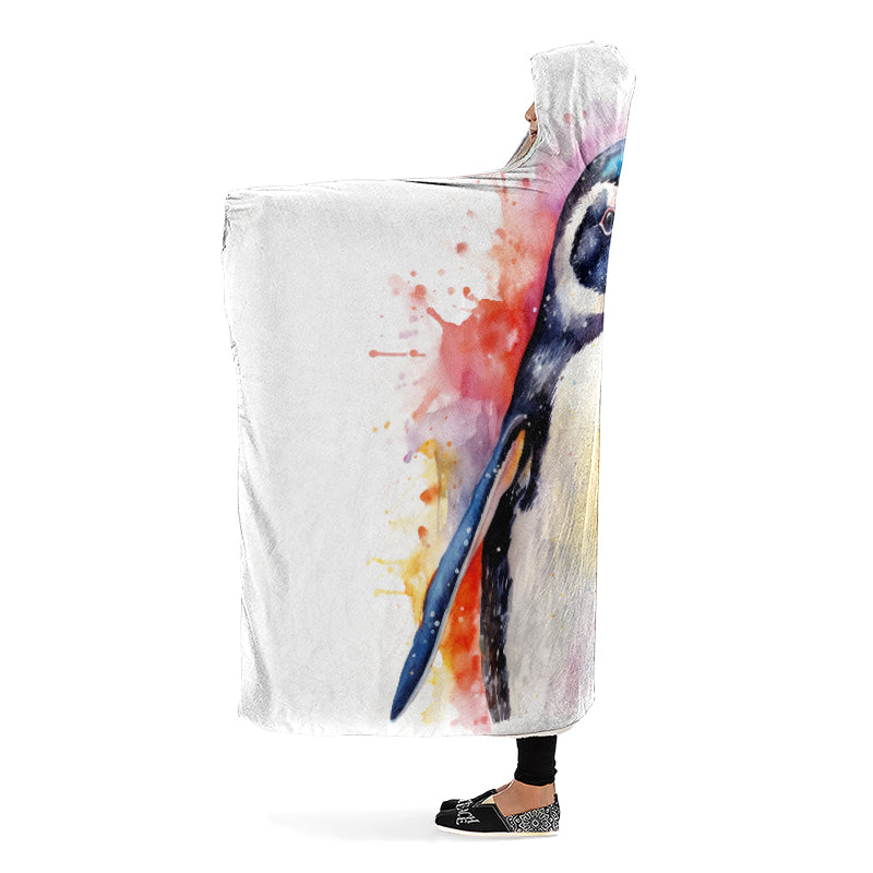 Colorful watercolor style penguin design on a white blanket held by a person. Side view.