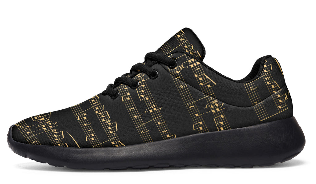 Black sneakers with gold musical note pattern on a white background