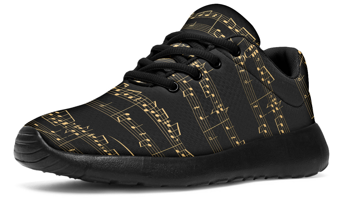 Black sneakers with gold musical note pattern on a white background