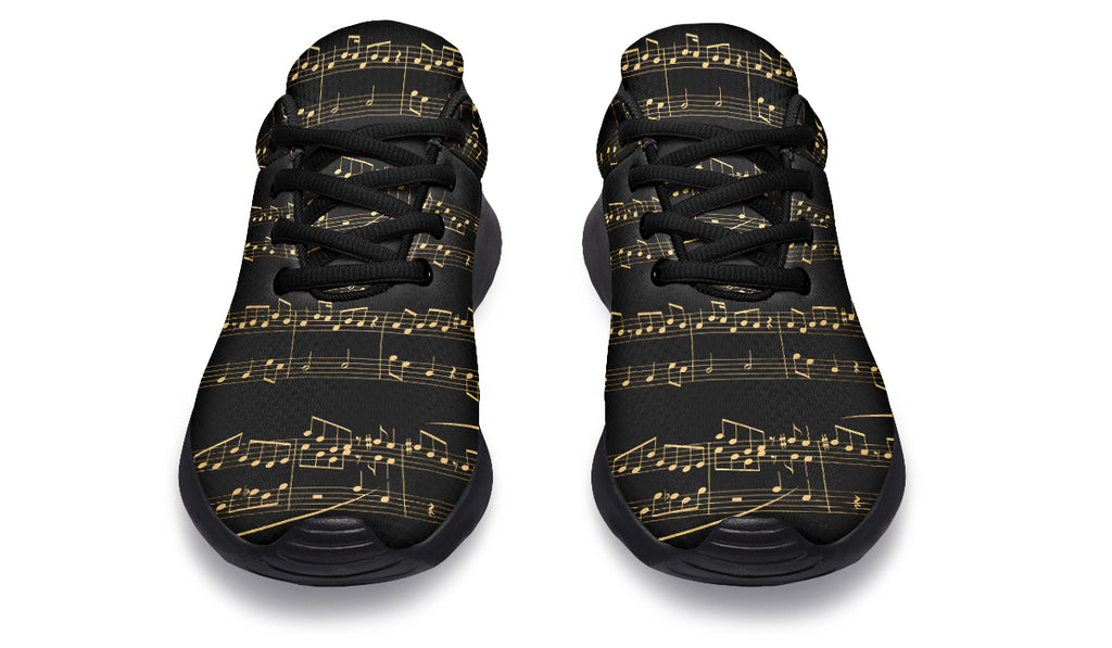 Black sneakers with gold musical note pattern on a white background