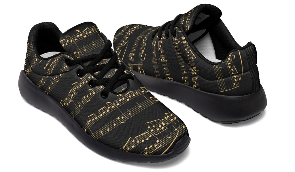Black sneakers with gold musical note pattern on a white background