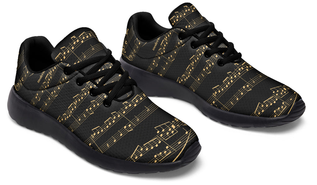 Black sneakers with gold musical note pattern on a white background