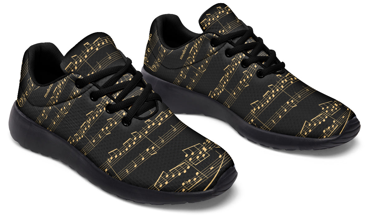 Black sneakers with gold musical note pattern on a white background