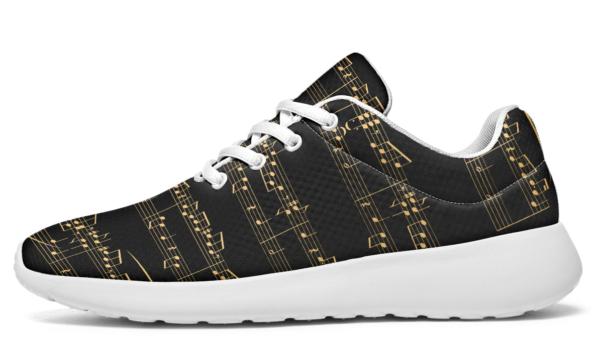 Black sneakers with gold musical note pattern on a white background