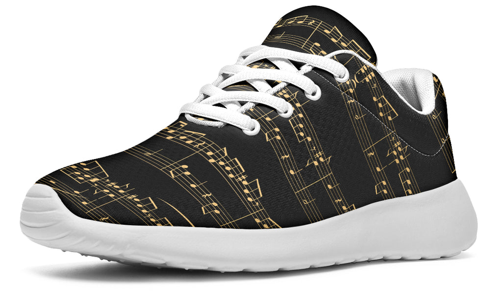Black sneakers with gold musical note pattern on a white background