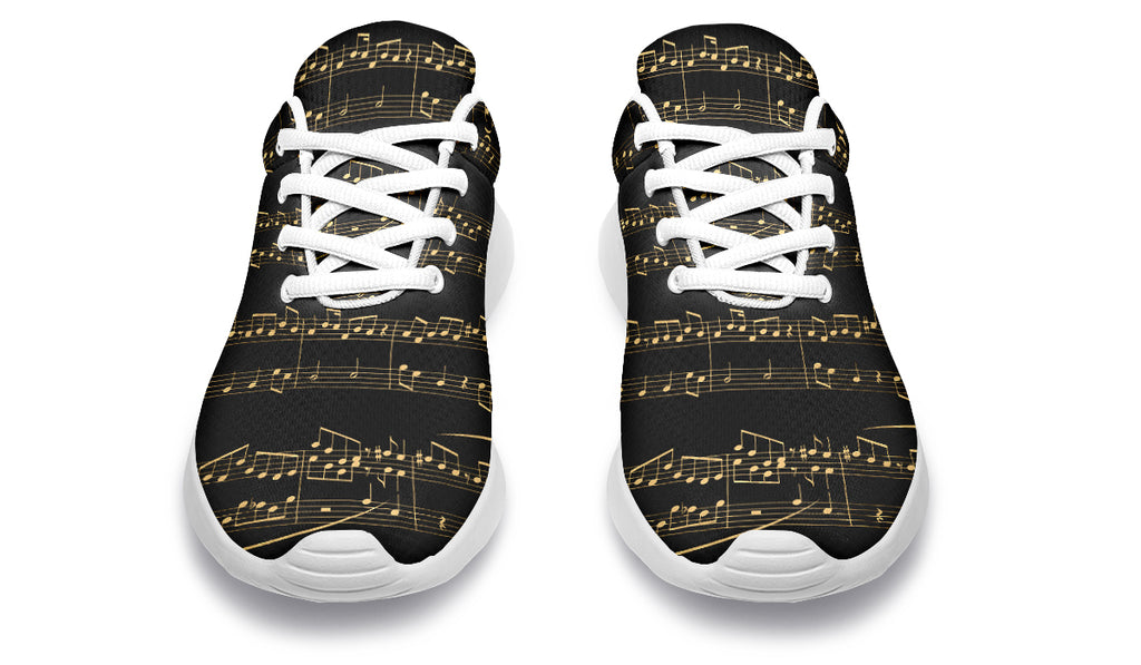 Black sneakers with gold musical note pattern on a white background