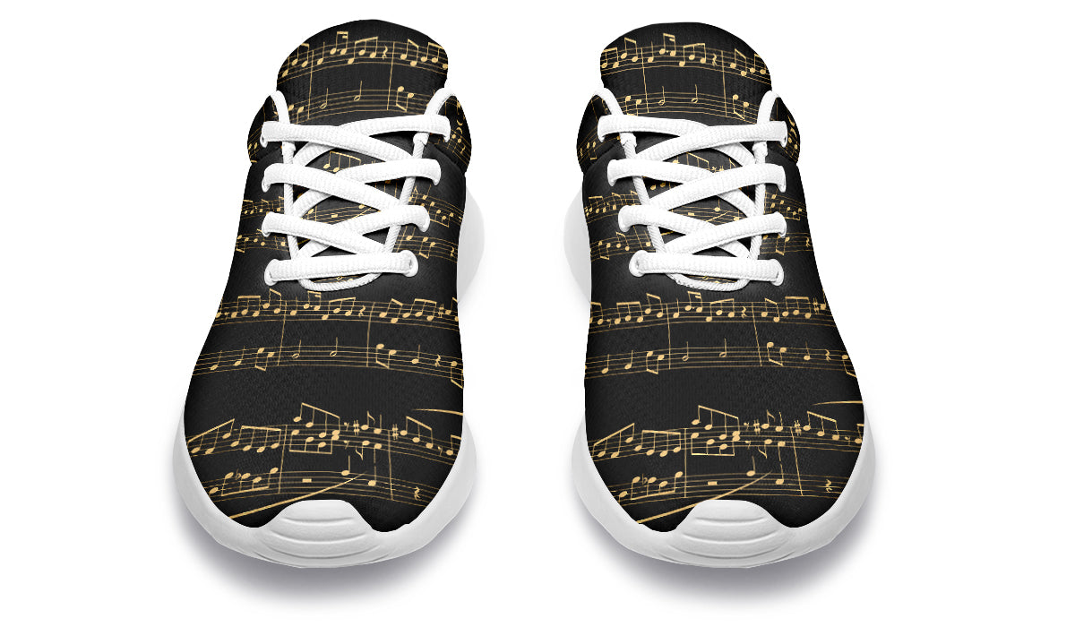 Black sneakers with gold musical note pattern on a white background