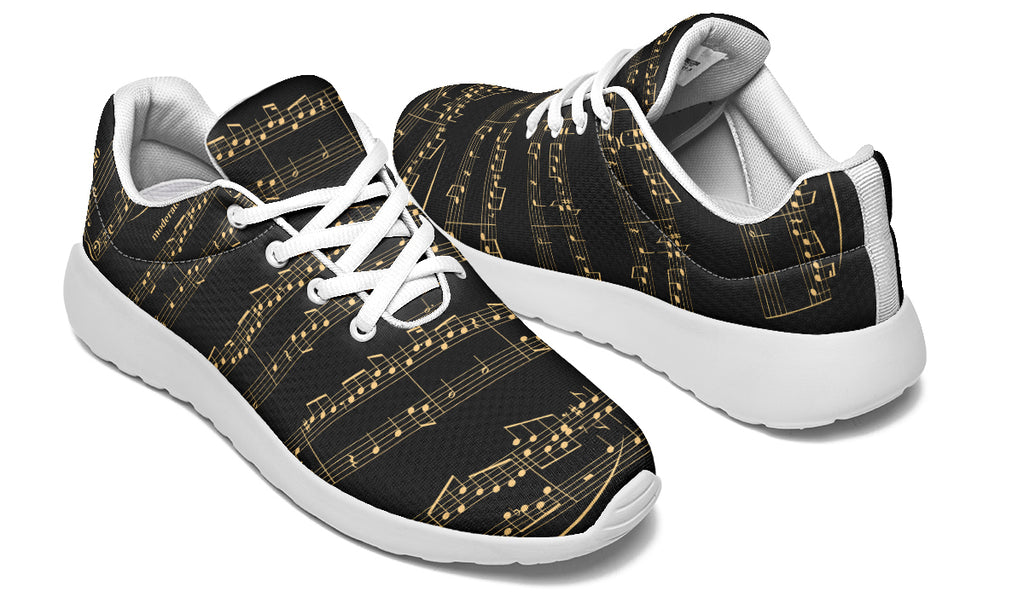 Black sneakers with gold musical note pattern on a white background