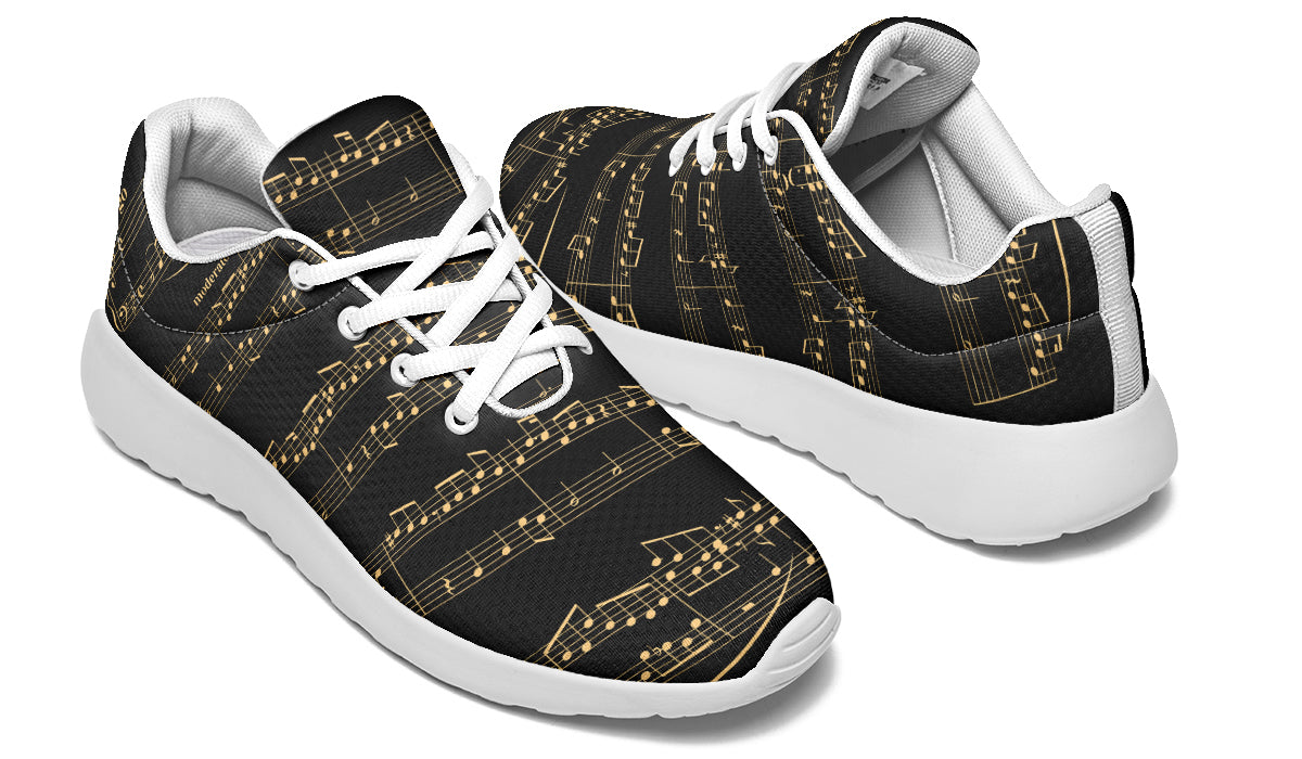 Black sneakers with gold musical note pattern on a white background
